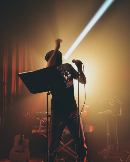 a man standing on a stage with a microphone.